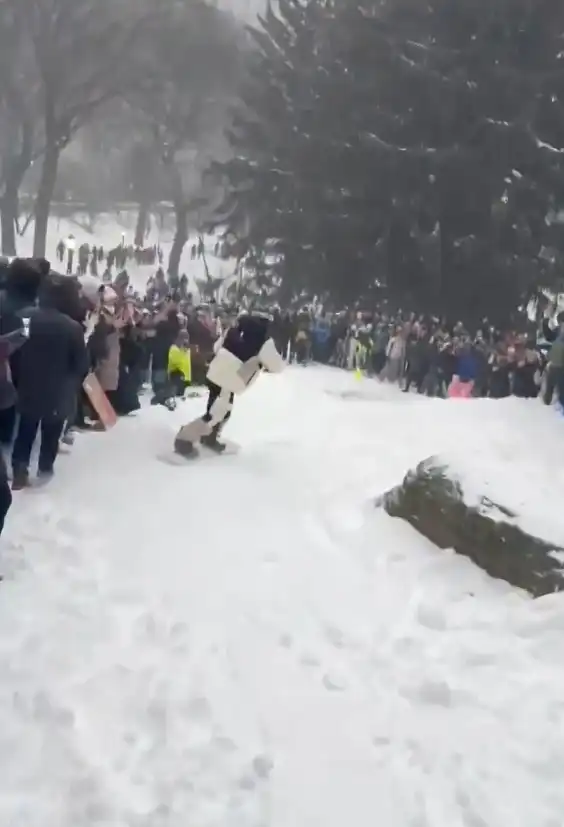 Olympic snowboarding champion Shaun White performs tricks in the snow in Central Park