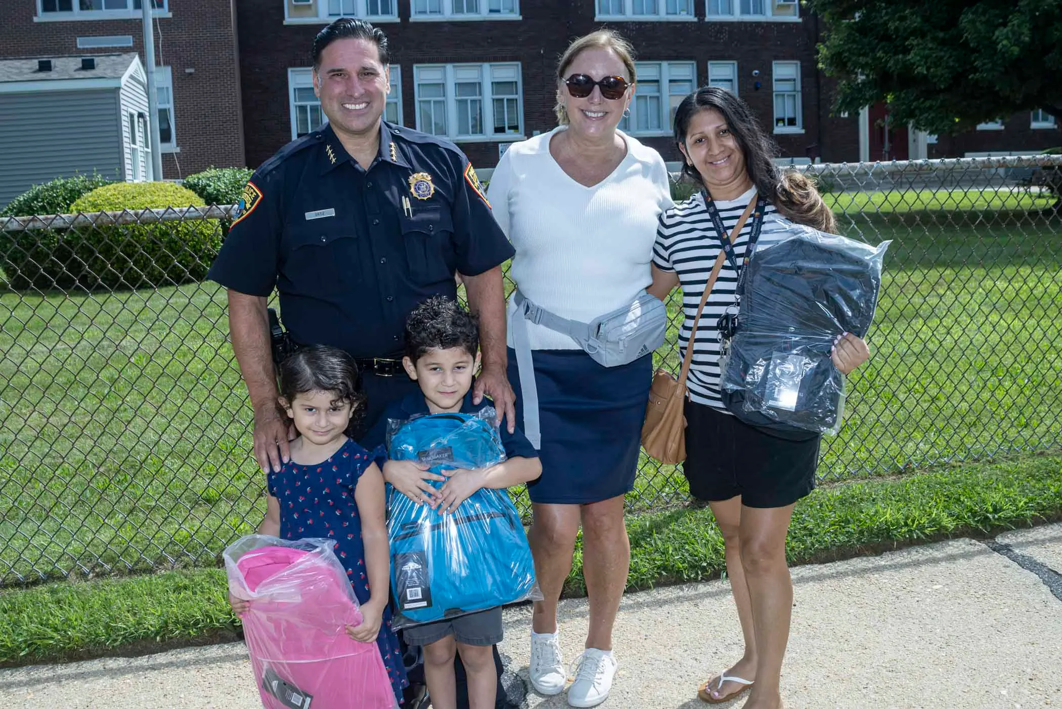 Legislator DeRiggi-Whitton and the Nassau PBA deliver backpacks for back to school