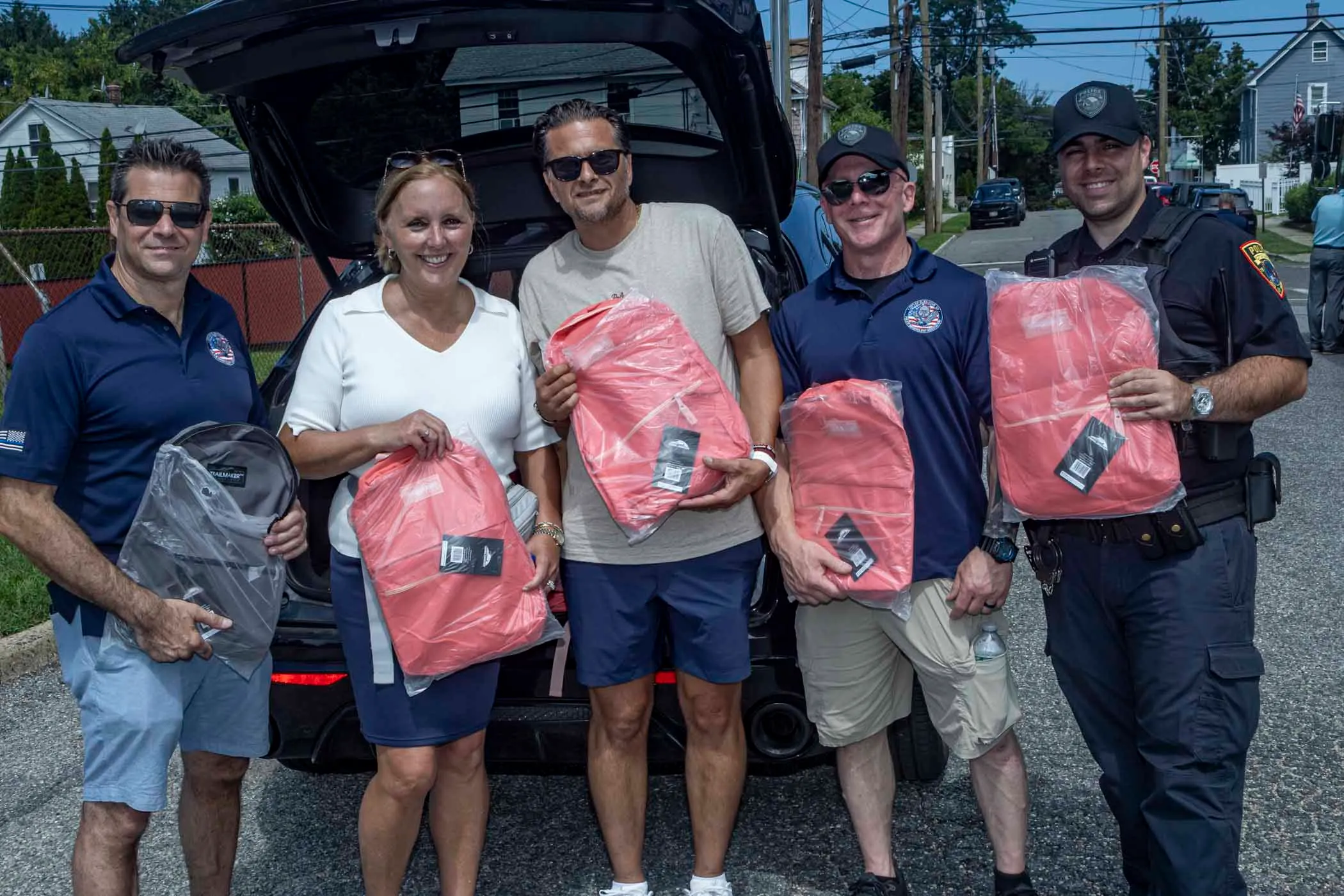 Legislator DeRiggi-Whitton and the Nassau PBA deliver backpacks for back to school