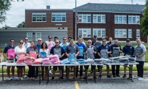 Legislator DeRiggi-Whitton and the Nassau PBA deliver backpacks for back to school