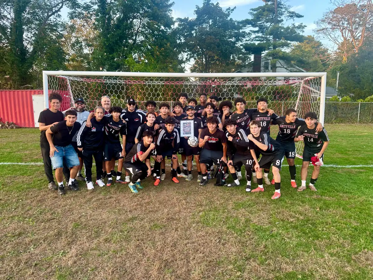 Amityville football coach Mike Abbondondolo celebrates his 200th career victory